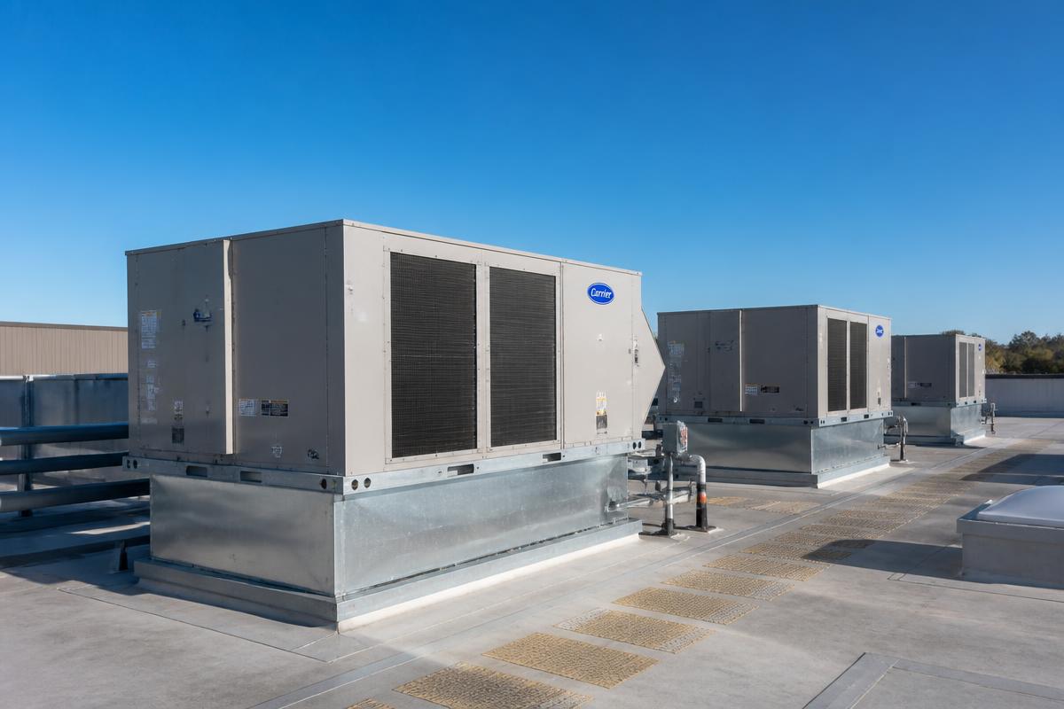 Commercial rooftop HVAC units on a warehouse roof